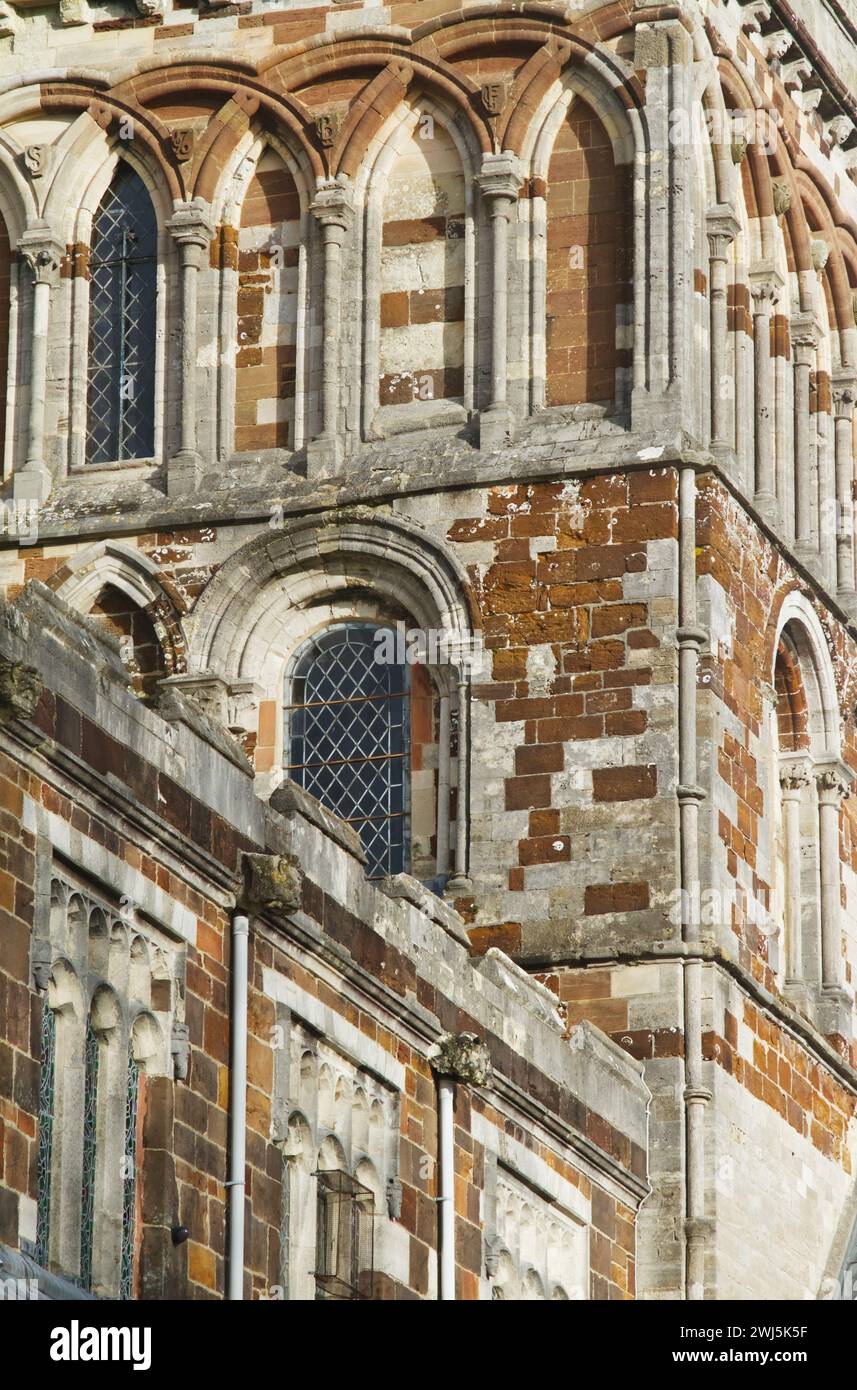 Dettaglio della muratura in pietra della chiesa parrocchiale della Torre centrale di Wimborne Minster con archi sagomati semicircolari forati da finestre a lancetta Foto Stock