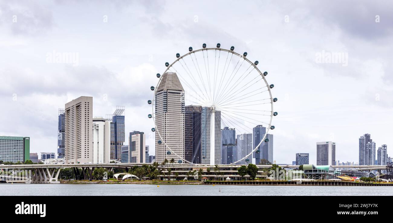 Marina Bay e lo skyline del centro di Singapore con la ruota panoramica Singapore Flyer Foto Stock