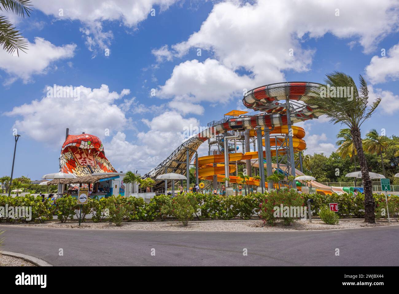 Vista panoramica del parco acquatico dell'hotel con scivoli d'acqua, sullo sfondo di un cielo blu con soffici nuvole bianche. Curacao. Willemstad. Foto Stock