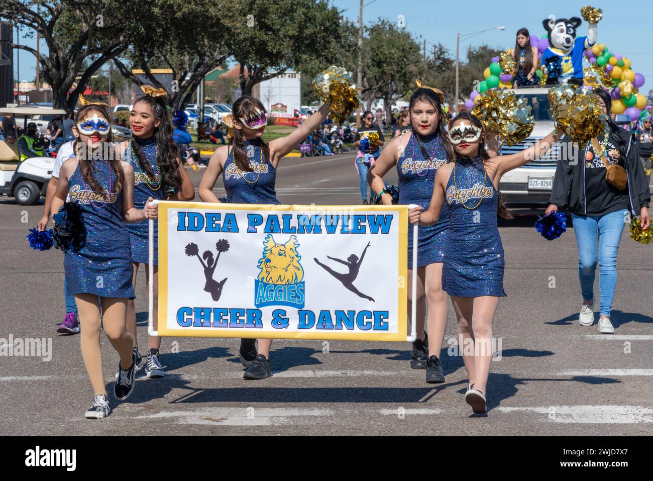 Ragazze della scuola IDEA Palmview tifo e gruppo di ballo ondate di pom nella 92a edizione annuale della Texas Citrus Fiesta Parade of Oranges 2024, Mission, Texas, USA. Foto Stock