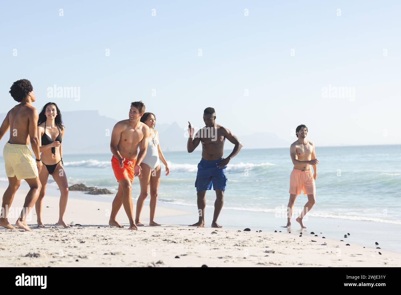 Gruppi diversi di amici trascorrono una giornata in spiaggia Foto Stock