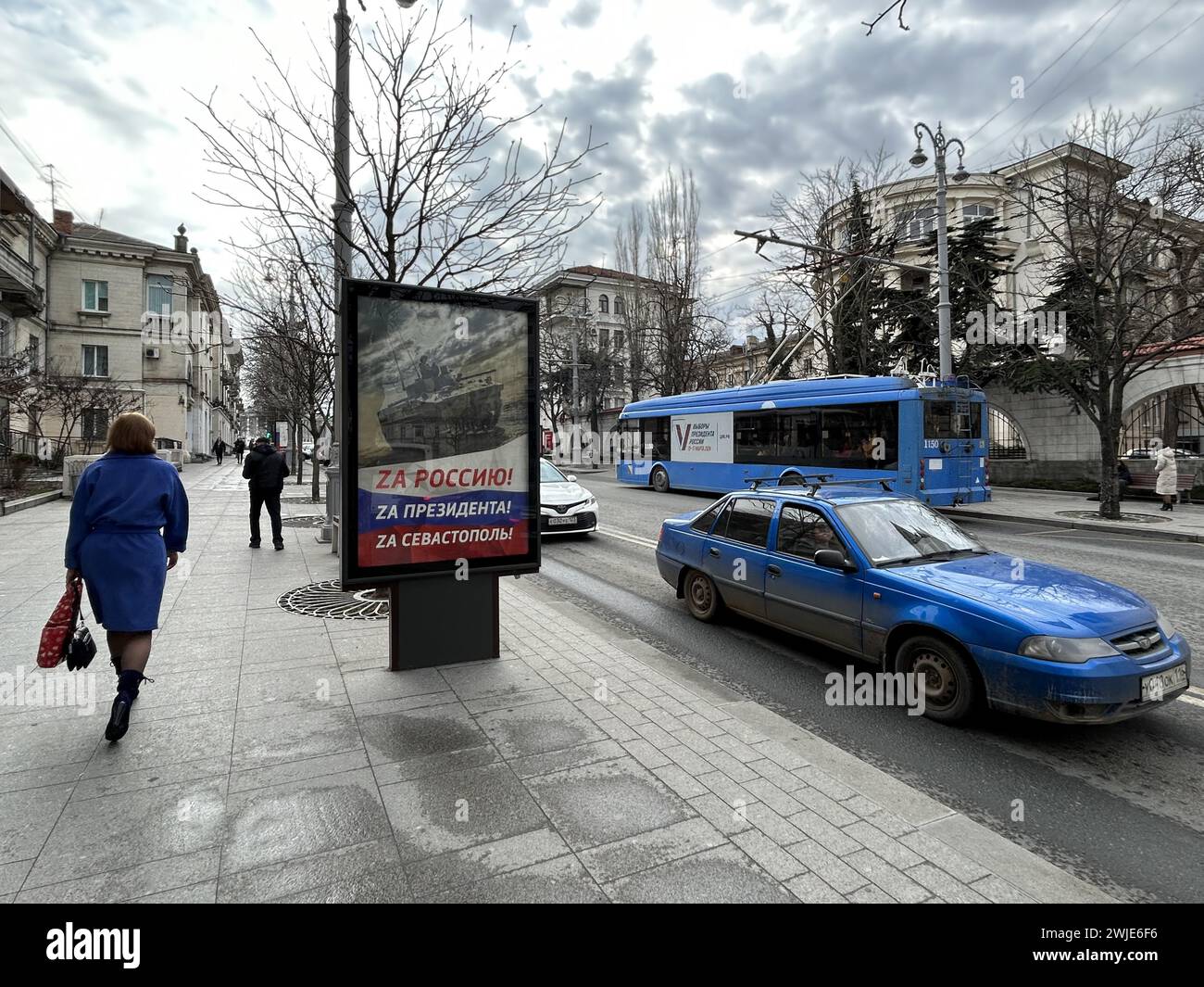 14 febbraio 2024, Ucraina, Sewastopol: In vista delle elezioni presidenziali russe del 17 marzo, ci sono manifesti in molti luoghi della città che promuovono la rielezione del leader del Cremlino Putin. Il poster nel centro della città portuale recita "per la Russia". Per il presidente. Per Sevastopol'. Molti Crimea sono grati a Putin per aver conquistato la penisola dall'Ucraina con la forza dieci anni fa e per averla integrata nel gigantesco impero. Quest'anno la Russia festeggia il decimo anniversario dell'annessione della Crimea, che fa parte dell'Ucraina ai sensi del diritto internazionale. Foto: Ulf Mauder/dpa Foto Stock