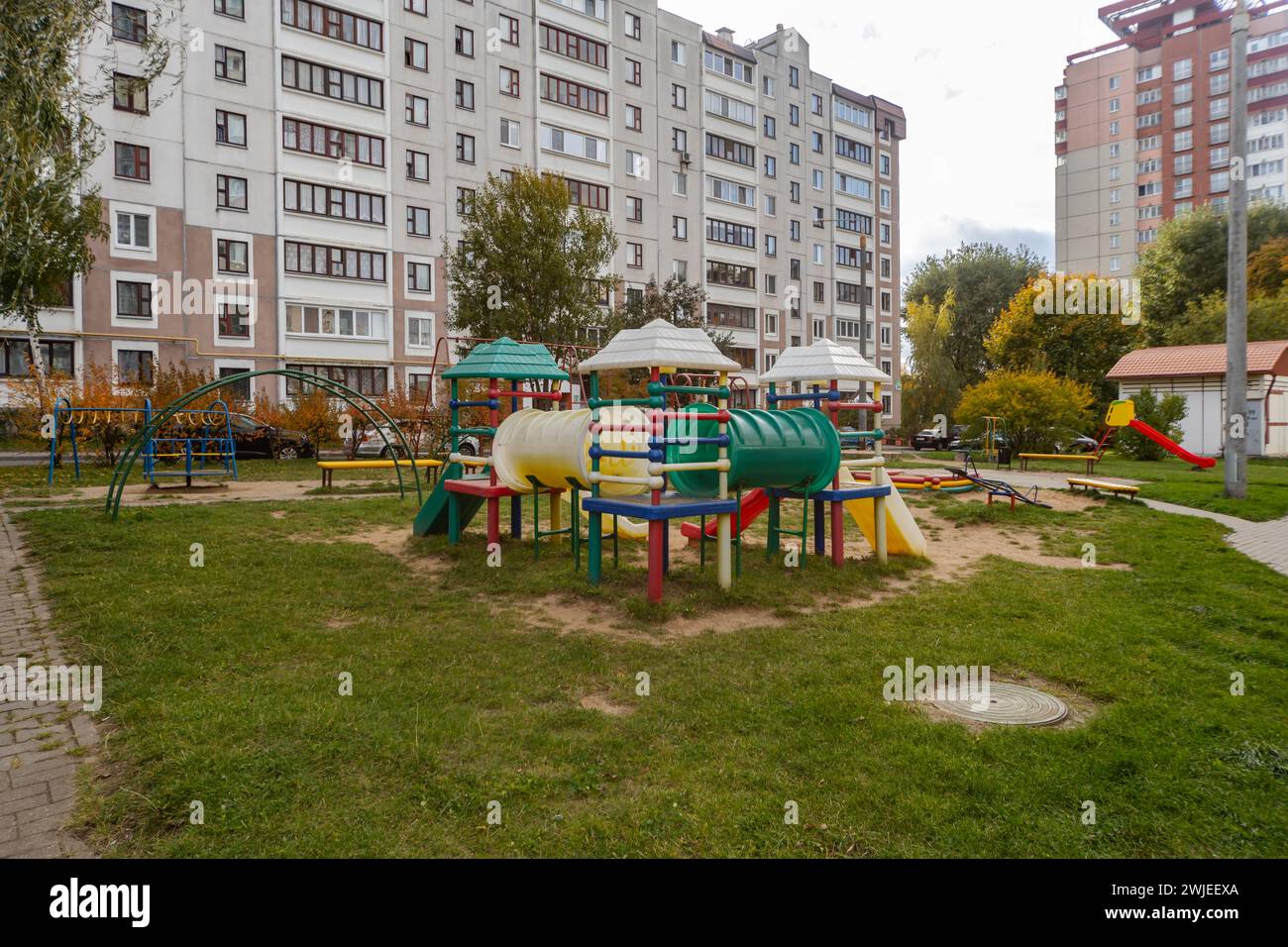 Campo sportivo e parco giochi per bambini nel cortile di un condominio in autunno Foto Stock