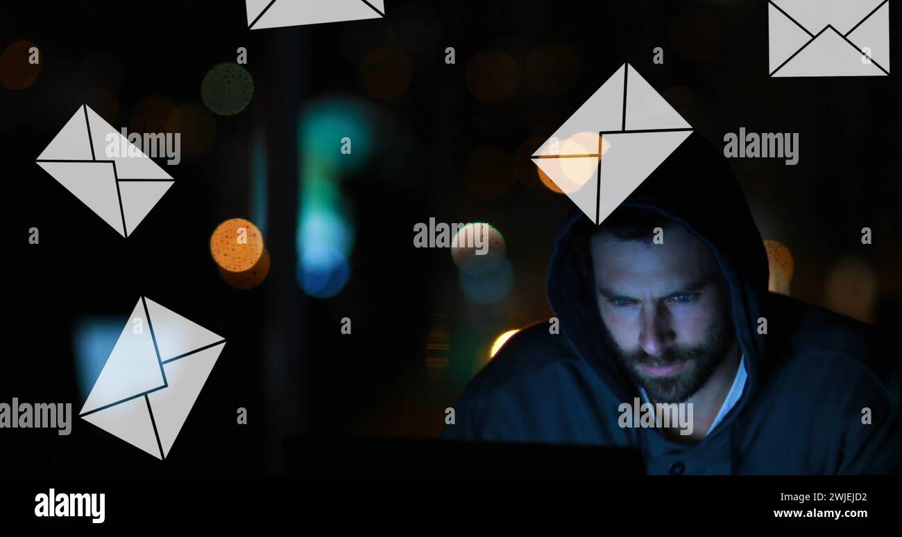 Uomo al computer con icone di messaggio cadute Foto Stock