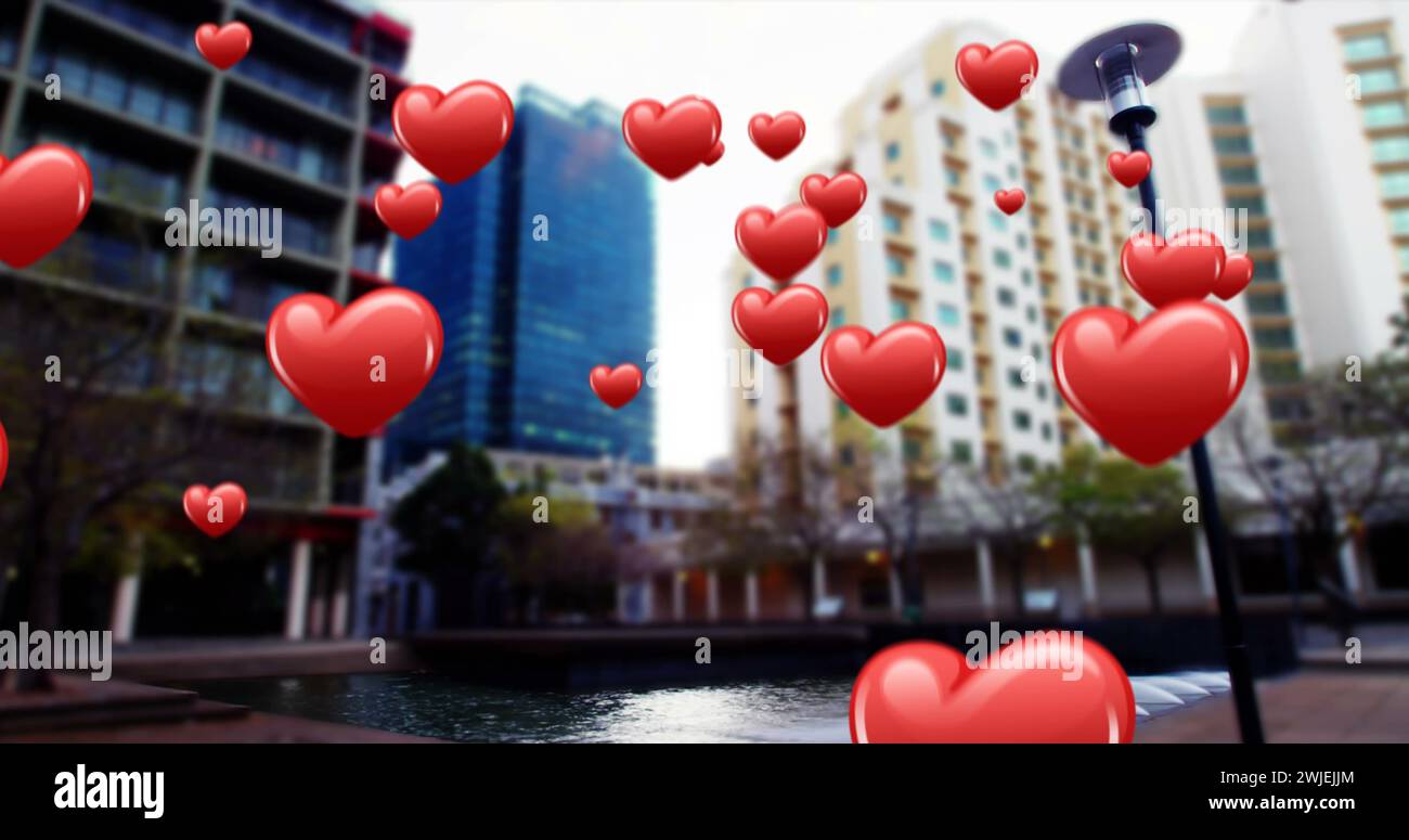 Icone a forma di cuore fluttuante sopra un paesaggio urbano Foto Stock