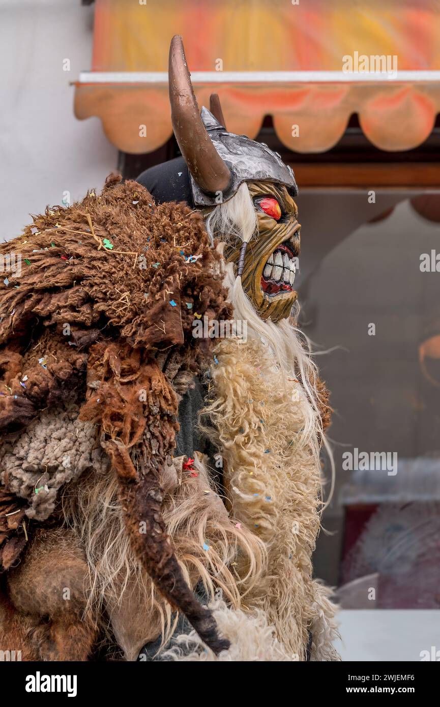 Reveller indossa maschera di legno e costume di carnevale. Evolene, Canton Vallese, Svizzera. Foto Stock