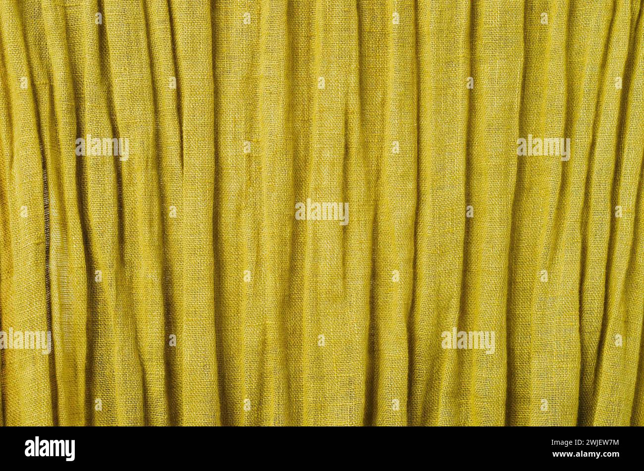 Stoffa di senape gialla con rughe Foto Stock