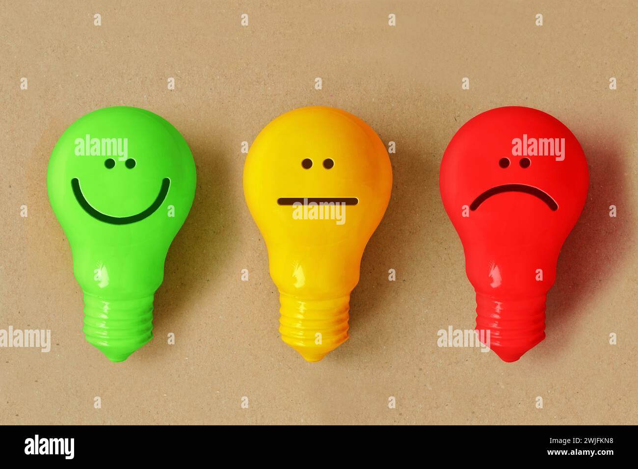 Lampadina verde, gialla e rossa con diverse espressioni facciali Foto Stock