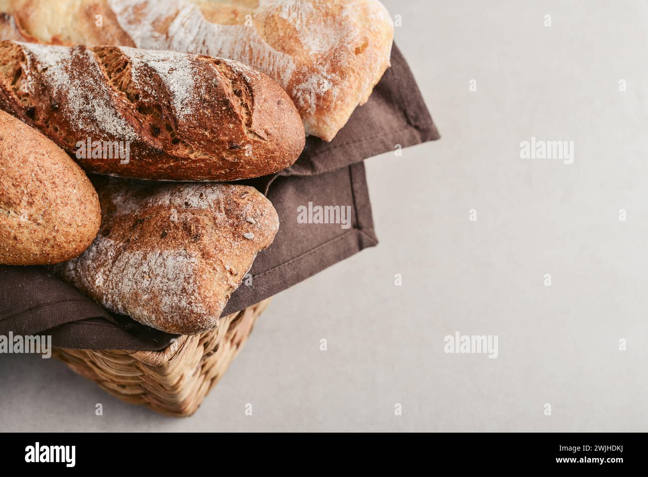 Prodotti da forno assortiti, tra cui pane, baguette e panini nel cestino, primo piano Foto Stock