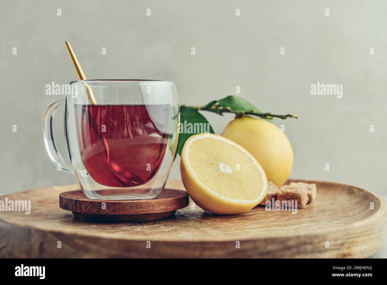 Tè in una tazza di bicchiere con frutti di arancia freschi di bergamotto su sfondo chiaro Foto Stock