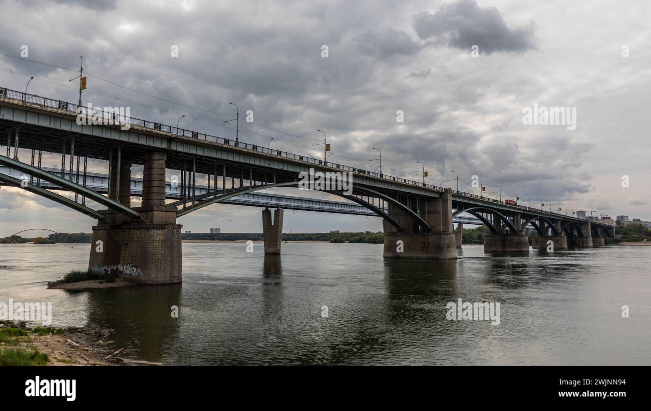 Due ponti attraversano il possente fiume OB a Novosibirsk e consentono il traffico ferroviario e stradale. Foto Stock