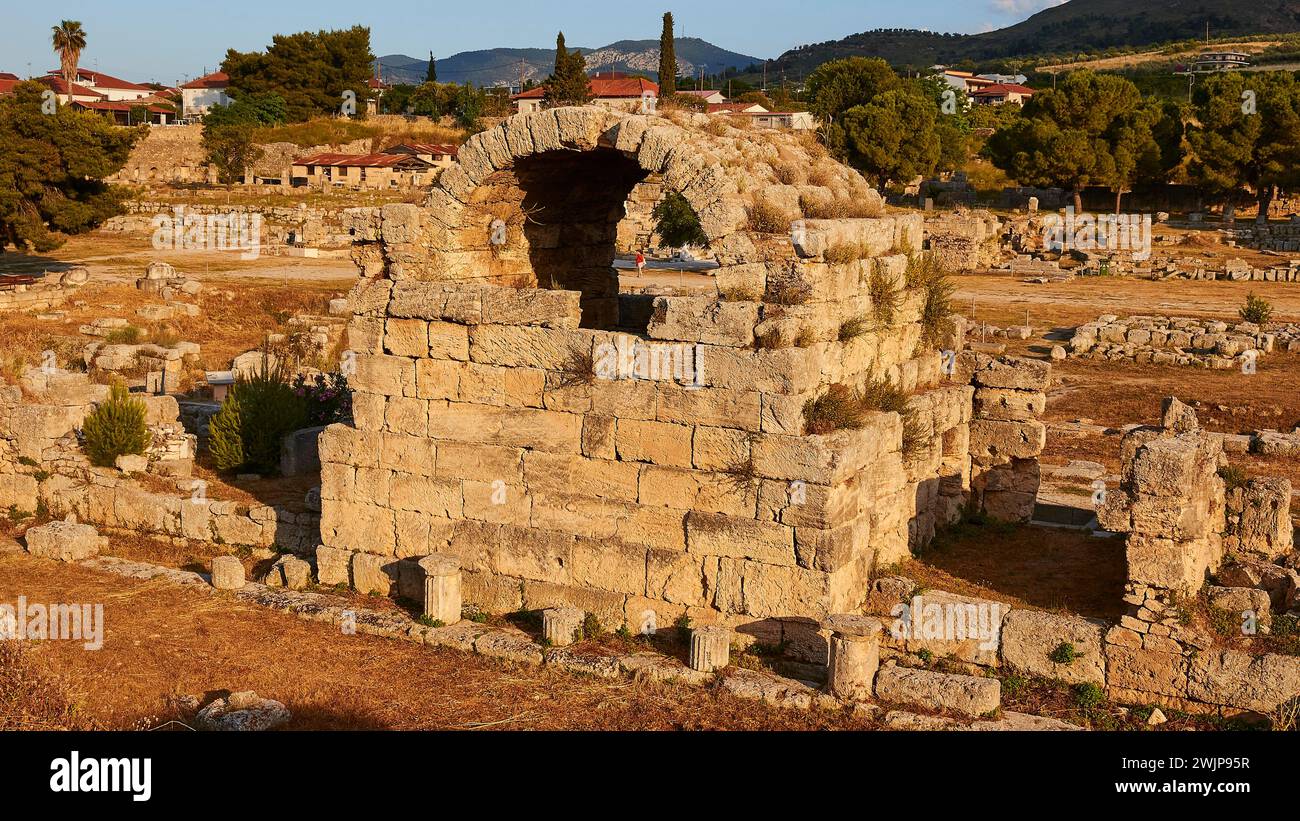 Rovine di un'antica struttura con vegetazione sullo sfondo, sito archeologico, Archea Korinthos, Corinto, Peloponneso, Grecia Foto Stock