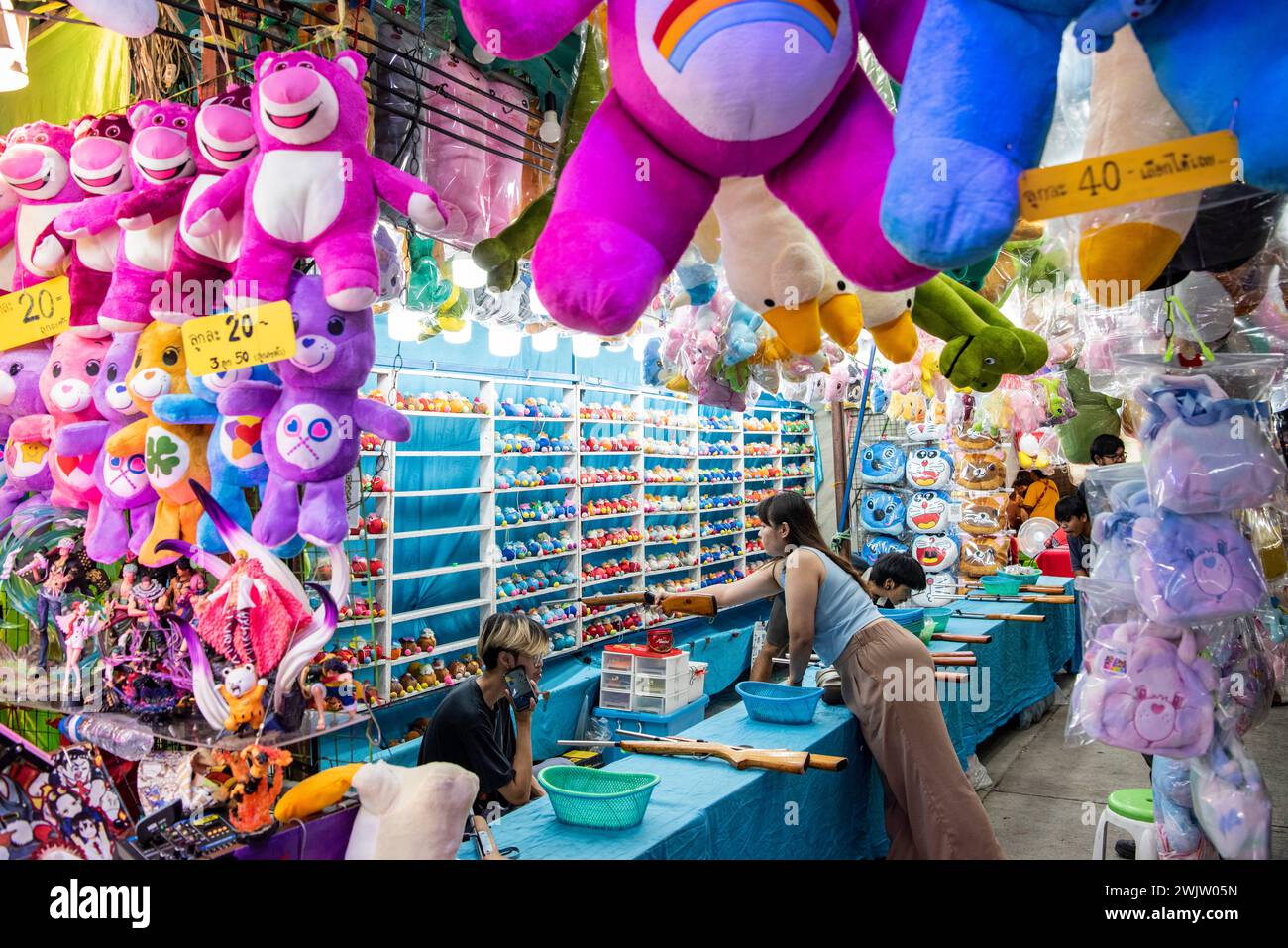 La gente ama un negozio di tiro al piattello presso la grande fiera dei divertimenti al Buffalo Race Festival o Wing Khwai nella città e provincia di Mueang Chonburi in Thailandia. Th Foto Stock