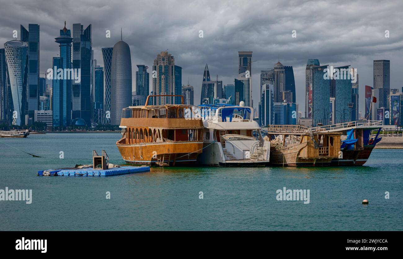 Skyline di Doha a Doha, in Qatar, dalla Corniche Street, ripresa pomeridiana con i dhows nei golfi arabi in primo piano Foto Stock