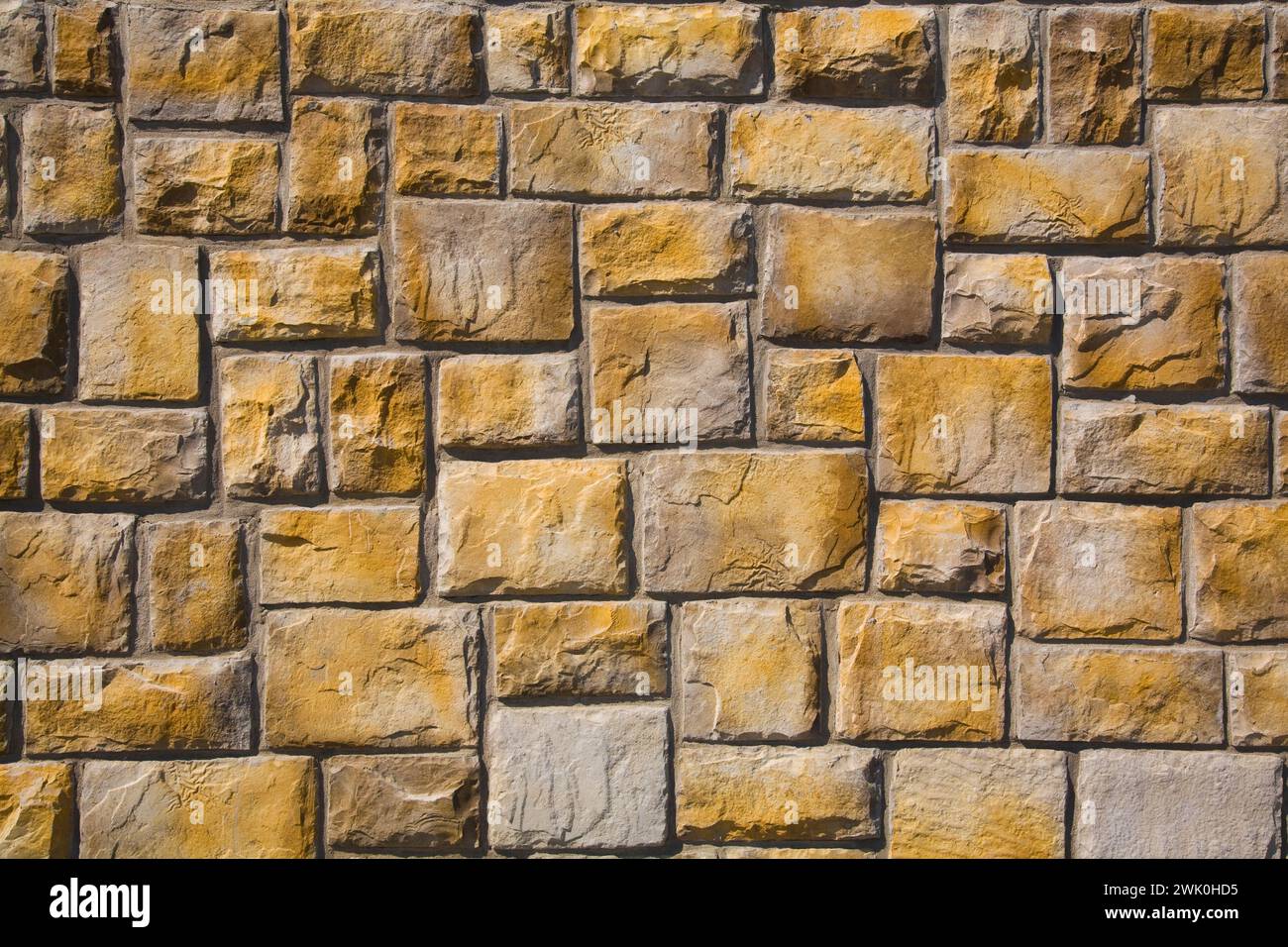 Primo piano di pareti in pietra con sfumature gialle. Foto Stock