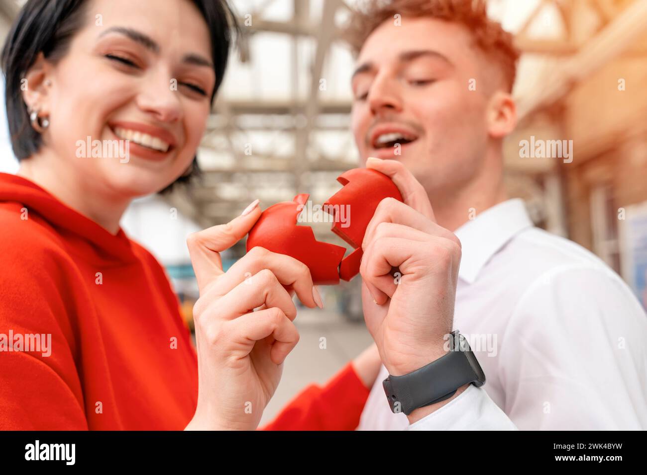 Donna e uomo che hanno due metà di cuore spezzato saranno Uniti in uno mentre si trovavano l'un l'altro. Concetto di amore e felicità Foto Stock