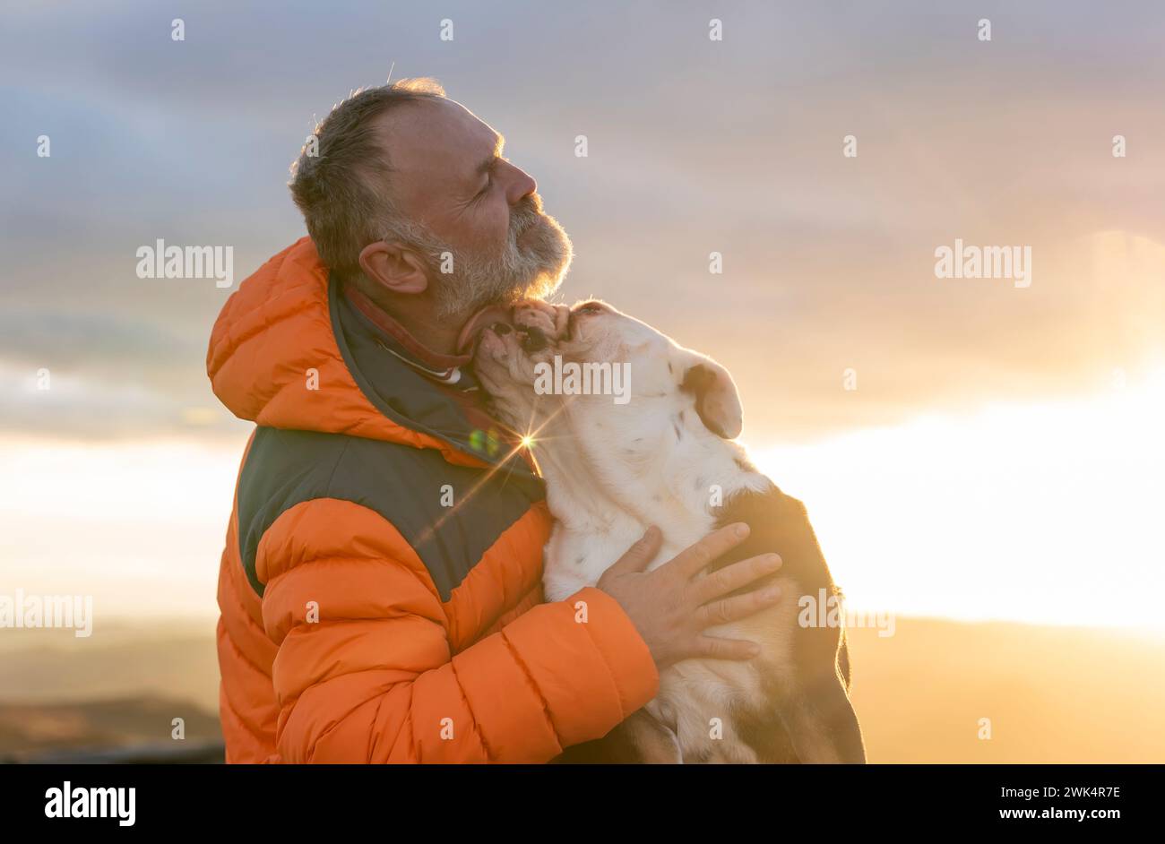 vecchio uomo maturo escursioni in montagna con il suo cane, esercizio fisico e fitness per il benessere, stile di vita sano e sorriso. Faccia di un signore anziano e maturo Foto Stock