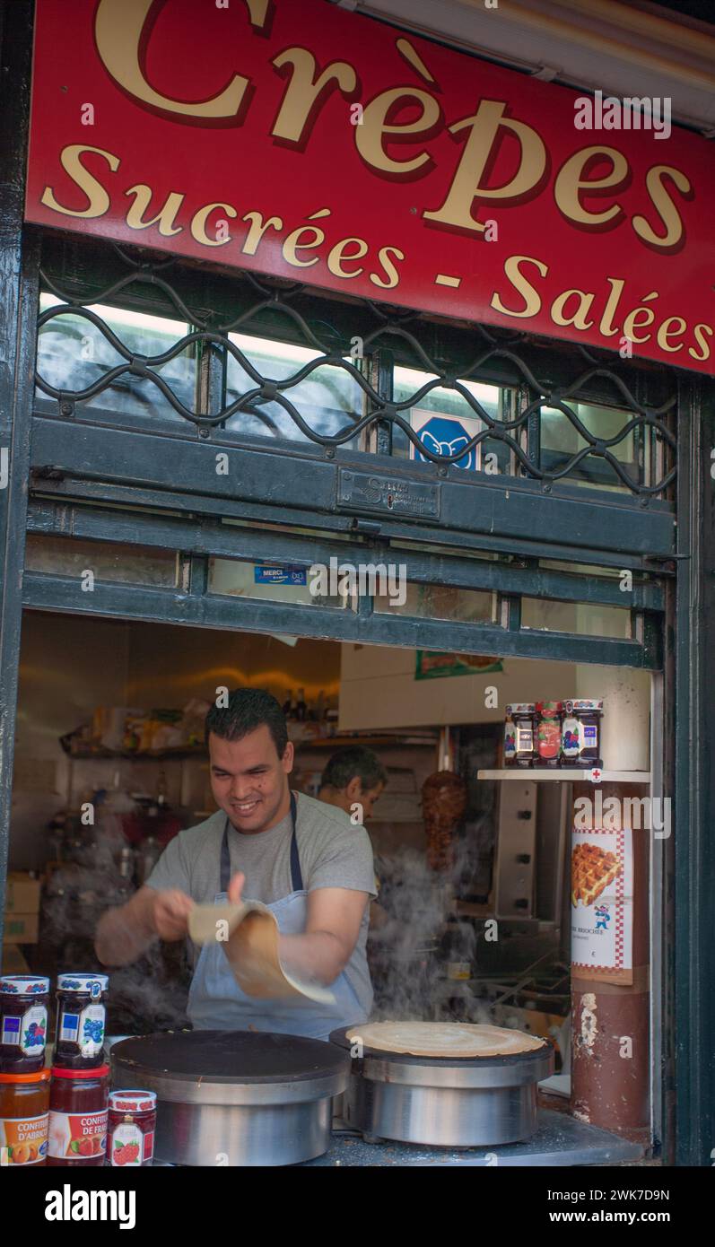 FRANCIA / Ile de France / Parigi / Creperie tradizionale con crepes venditrice a Montmartre. Francese uomo che produce crepes a una Creperie a Montmartre Foto Stock