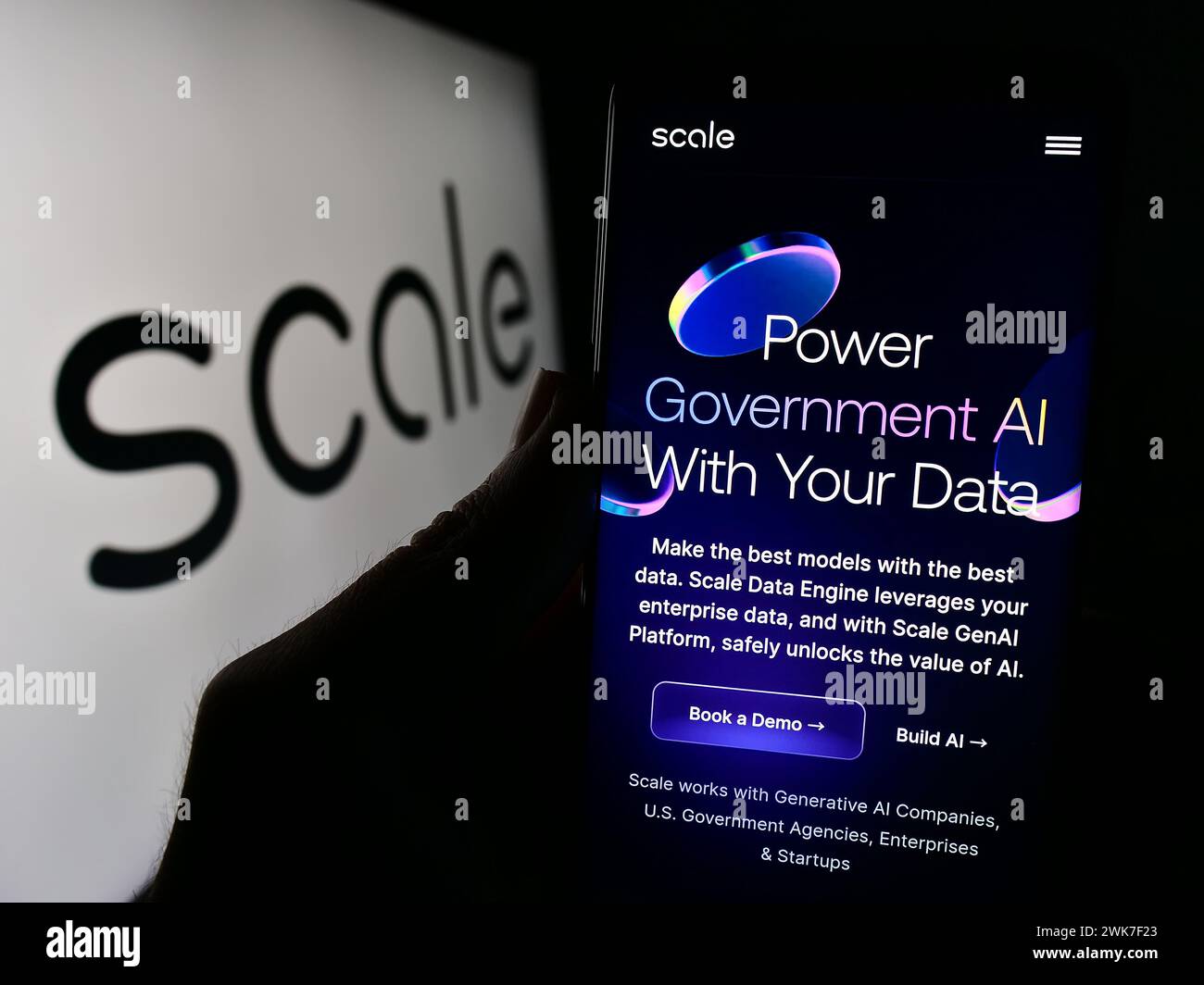 Persona che possiede uno smartphone con la pagina Web della società statunitense di intelligenza artificiale Scale ai Inc. Davanti al logo. Messa a fuoco al centro del display del telefono. Foto Stock