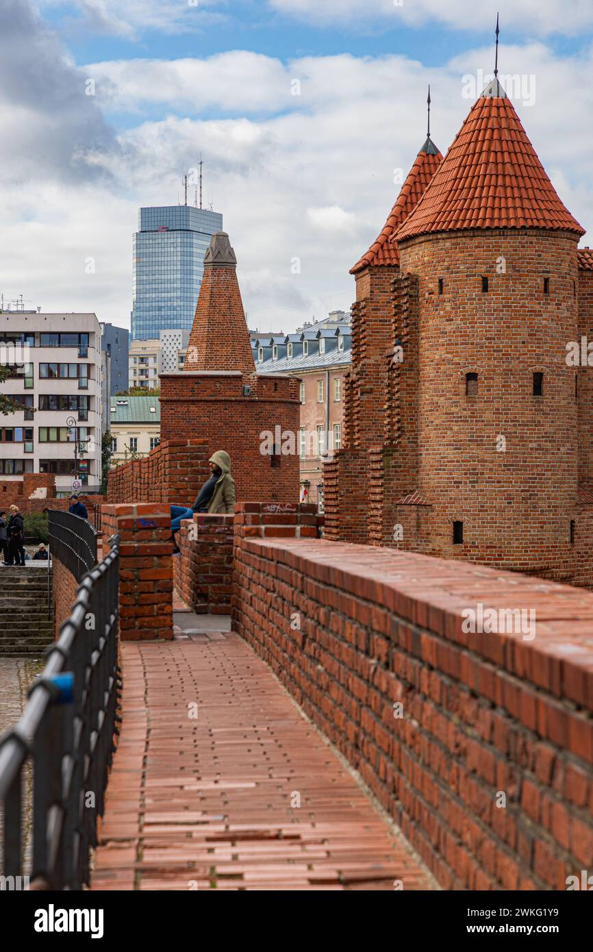 Varsavia, Polonia - 15 ottobre 2023: Splendide fortificazioni in mattoni rossi della città vecchia con mura e torri difensive e varsavia barbacane Foto Stock