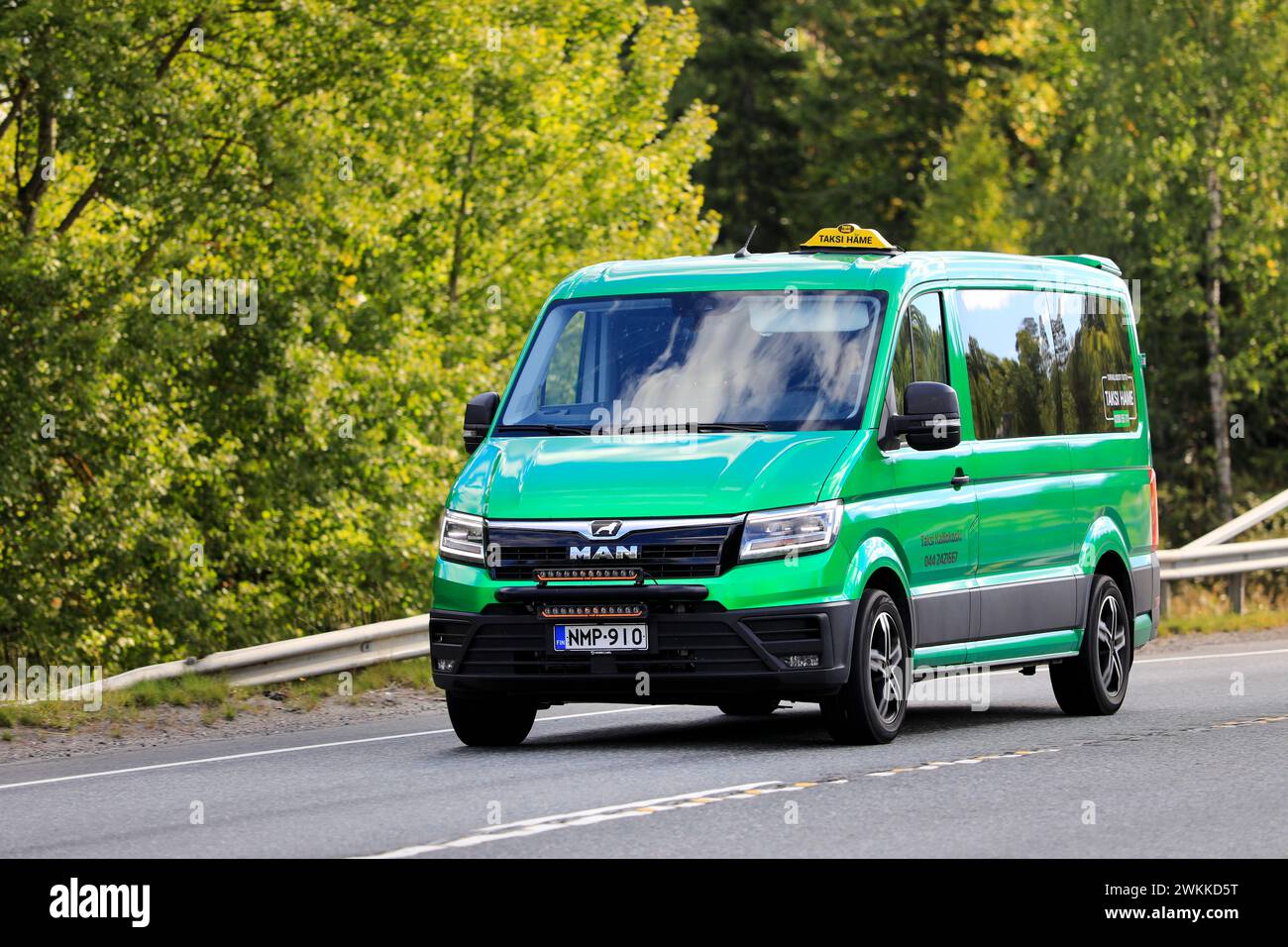 Green 2022 MAN taxi minibus TGE taxi ad alta velocità sull'autostrada contro il verde del verde. Forte, Finlandia. 9 settembre 2022. Foto Stock