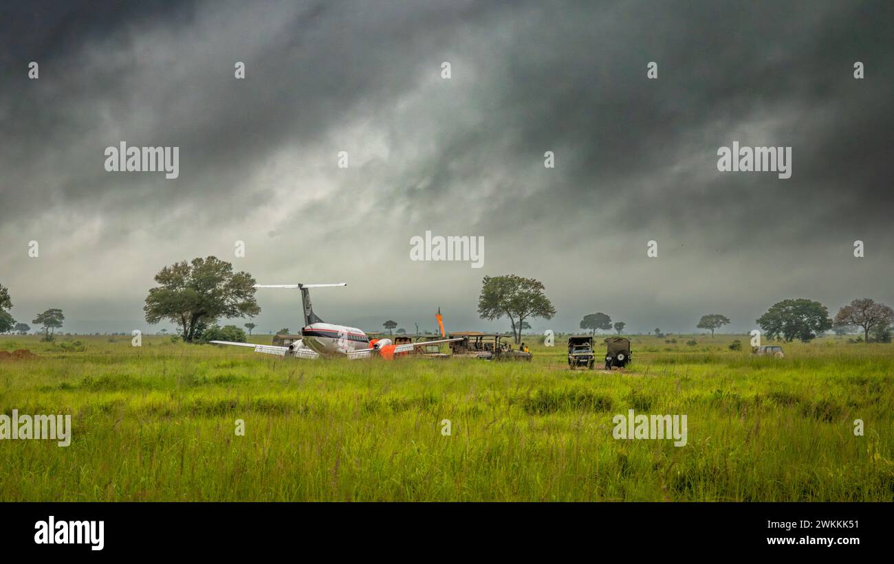 Veicoli da safari 4x4 parcheggiati vicino a un piccolo aereo presso la pista di atterraggio di Kikoboga nel Parco Nazionale di Mikumi in Tanzania. Foto Stock