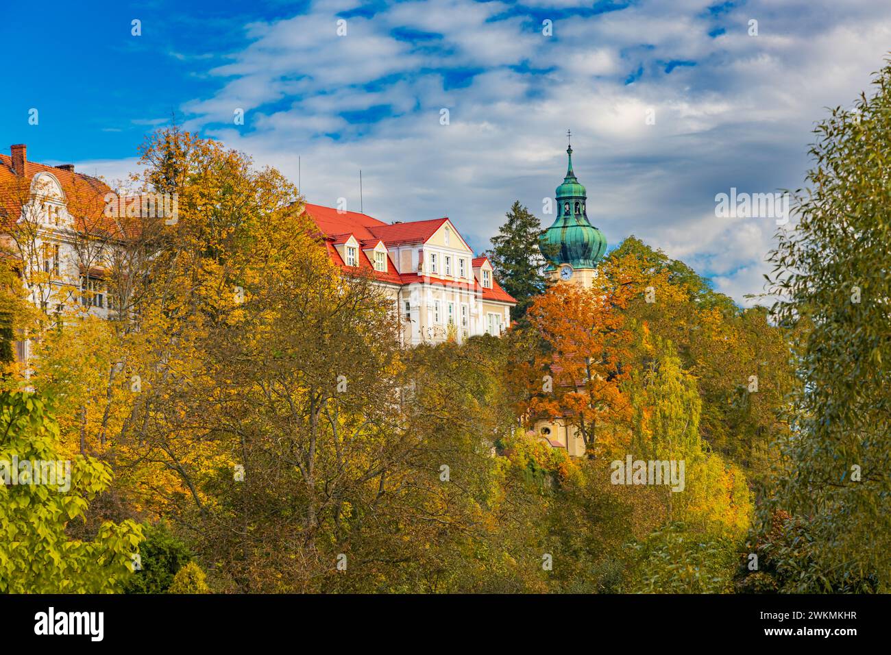 Polanica-Zdroj, Polonia - 21 ottobre 2023: Facciata di uno speciale centro educativo vista dall'altro lato del piccolo fiume dietro alti alberi e cespugli Foto Stock
