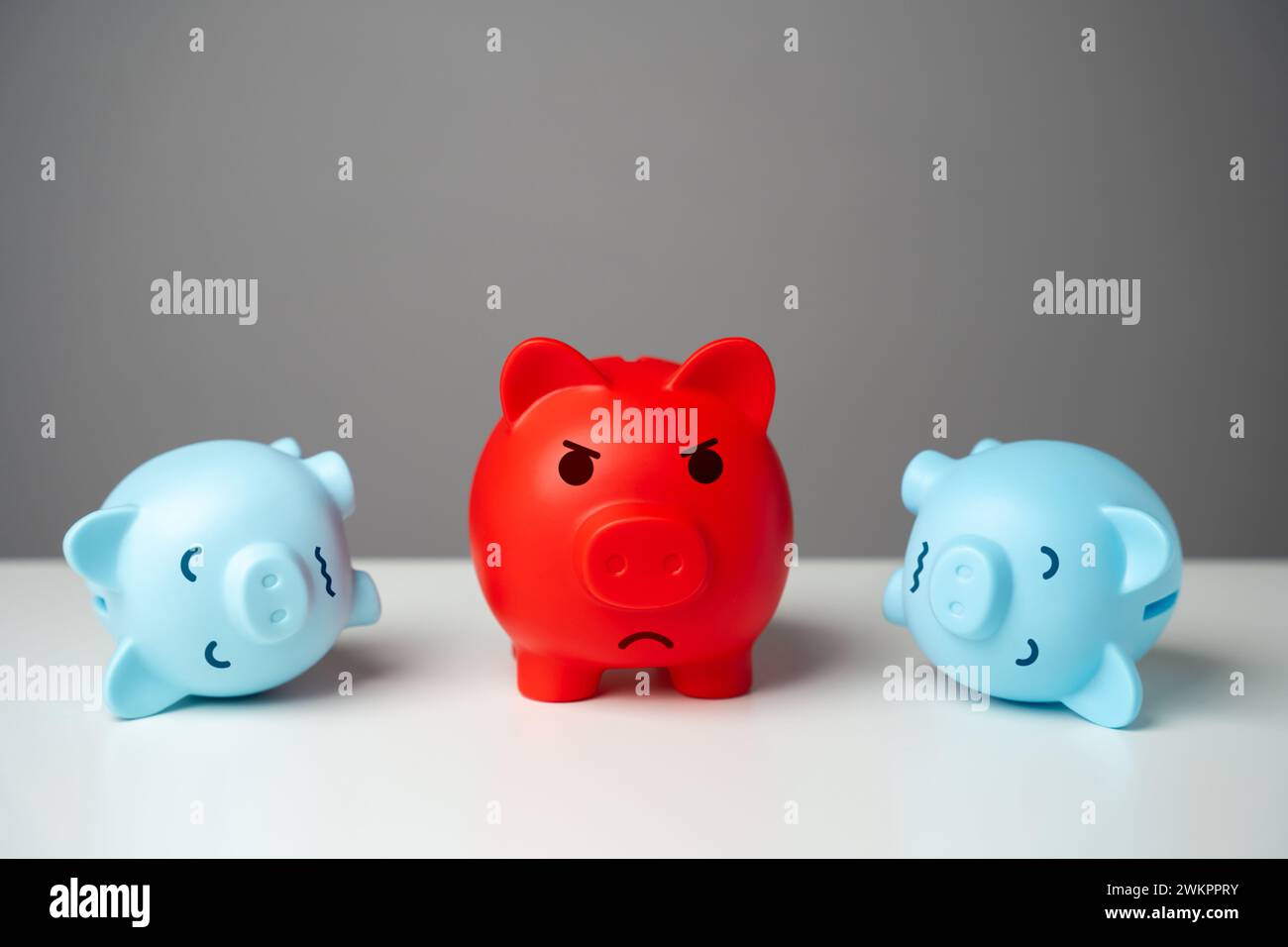 Un salvadanaio rosso, pieno di soldi, tra quelli blu esausti. Squilibrio finanziario. C'è una grande differenza tra i segmenti del populismo Foto Stock