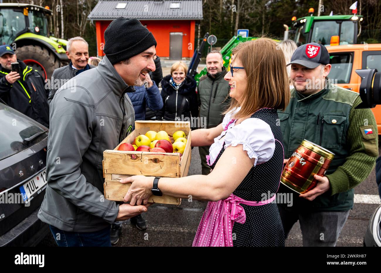 Hora Svateho Sebestiana, Repubblica Ceca. 22 febbraio 2024. Azione di protesta degli agricoltori contro la politica agraria dell’Unione europea, Hora Svateho Sebestiana/Reitzenhain, valico di frontiera tra Repubblica ceca e Germania, Repubblica ceca, 22 febbraio, 2024. un rappresentante degli agricoltori tedeschi, a sinistra, riceve una donazione dagli agricoltori cechi durante una riunione al confine. Crediti: Ondrej Hajek/CTK Photo/Alamy Live News Foto Stock