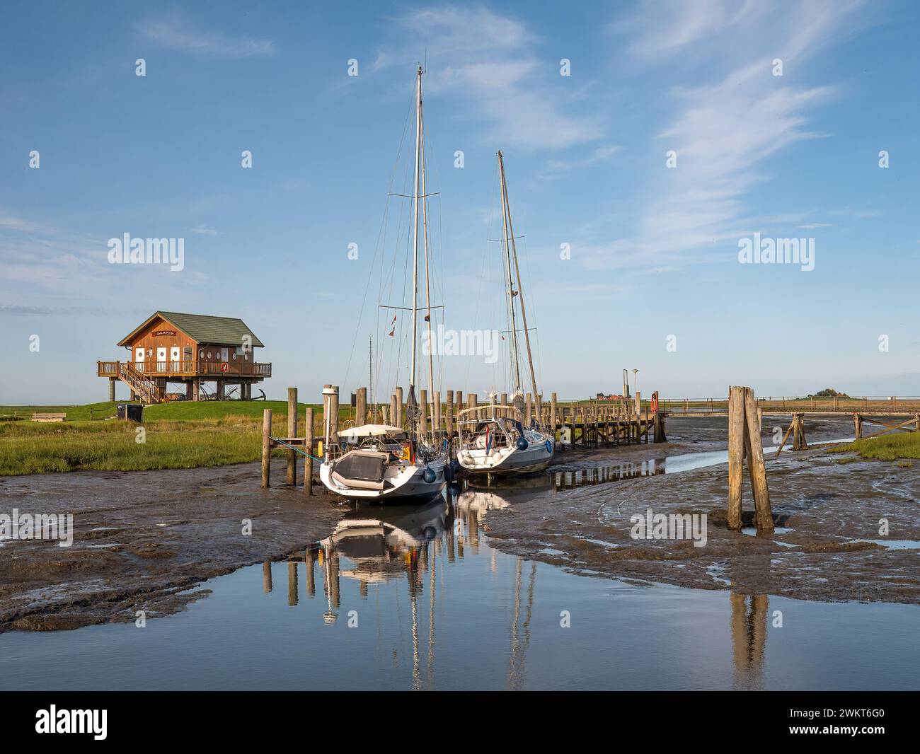 Barche a vela con bassa marea nel porto di Halligen Hooge, Frisia settentrionale, Schleswig-Holstein, Germania Foto Stock