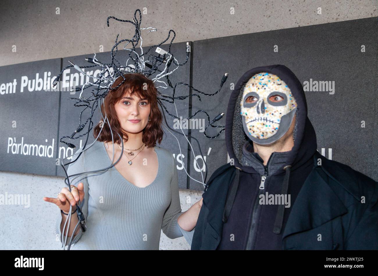 Edimburgo, Scozia. 22 febbraio 2024. Modelli che indossano un copricapo realizzato con rifiuti elettrici e un modello in un frontalino realizzato con vivai al di fuori del Parlamento scozzese, per sensibilizzare i nostri clienti sui nostri livelli di spreco e inquinamento del consumo di materiale. © Richard Newton / Alamy Live News Foto Stock