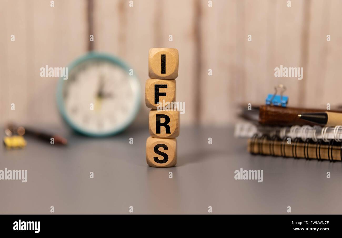 C'è un cubo di legno con la parola IFRS. È l'abbreviazione di International Financial Reporting Standard come immagine accattivante. Foto Stock