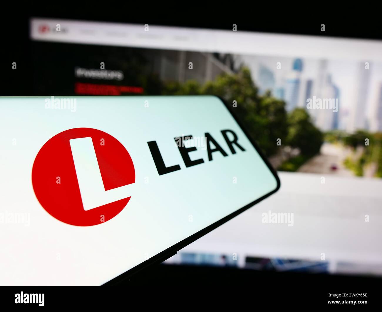 Telefono cellulare con il logo della società americana di forniture automobilistiche Lear Corporation davanti al sito Web. Mettere a fuoco la parte centrale sinistra del display del telefono. Foto Stock