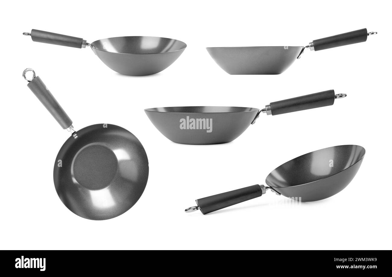 Vuoti woks metallici isolati su bianco, set Foto Stock