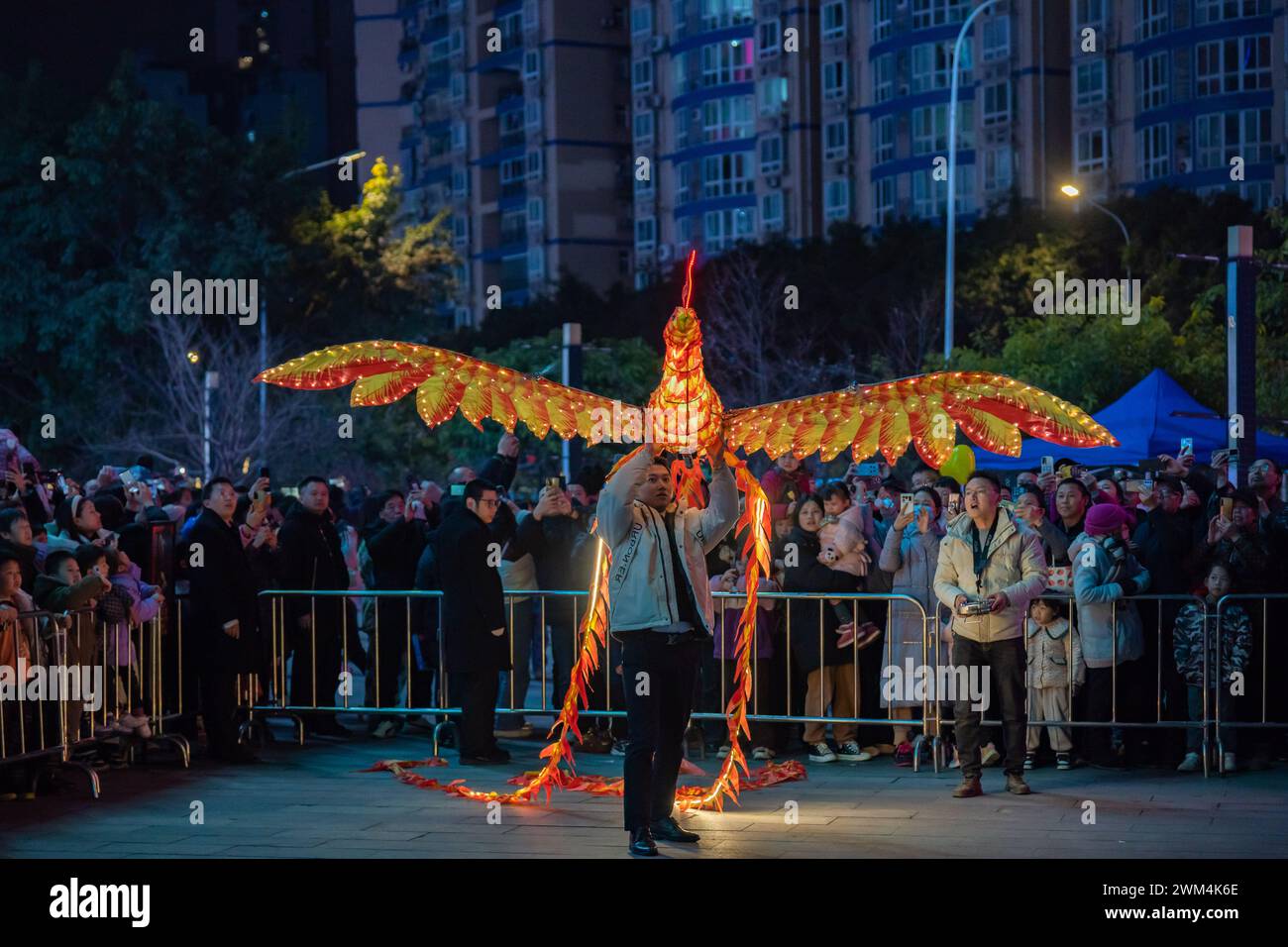 Chongqing, Cina. 23 febbraio 2024. I turisti stanno guardando uno spettacolo telecomandato del Double Phoenix Flying Performance, che è dotato di un gruppo di potenza, rilasciato da un artista in una piazza a Chongqing, in Cina, il 23 febbraio 2024. (Foto di Costfoto/NurPhoto) credito: NurPhoto SRL/Alamy Live News Foto Stock