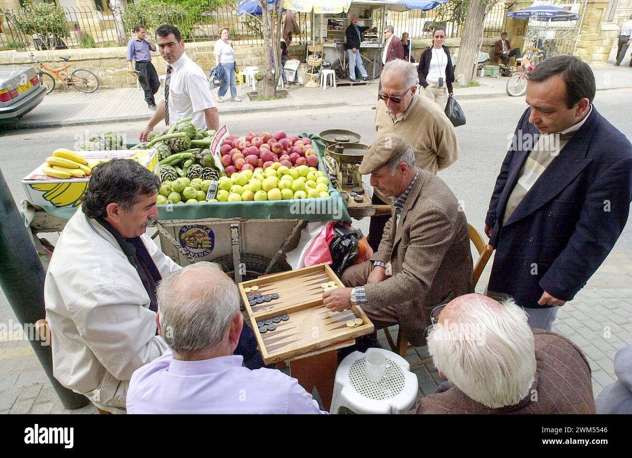 Il mercante del nord di Nicosia ama sempre parcheggiare il suo carro di frutta sul lato della strada per un buon gioco di tavla (backgammon). Foto Stock