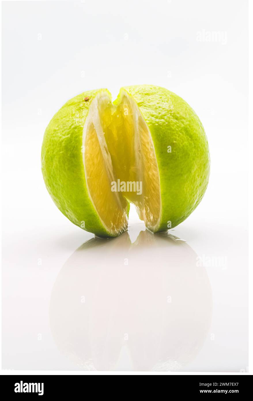 Frutta fresca tagliata a metà con riflesso e sfondo bianco Foto Stock