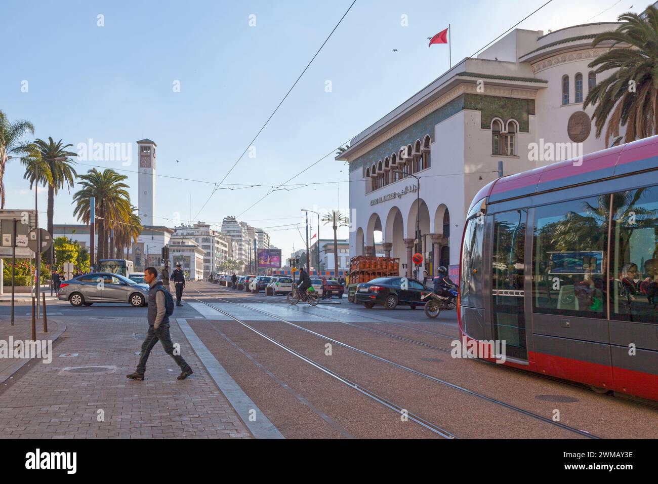 Casablanca, Marocco - 17 gennaio 2019: Tram che passa dall'ufficio postale in Piazza Mohammed V verso la torre dell'orologio del municipio. Foto Stock