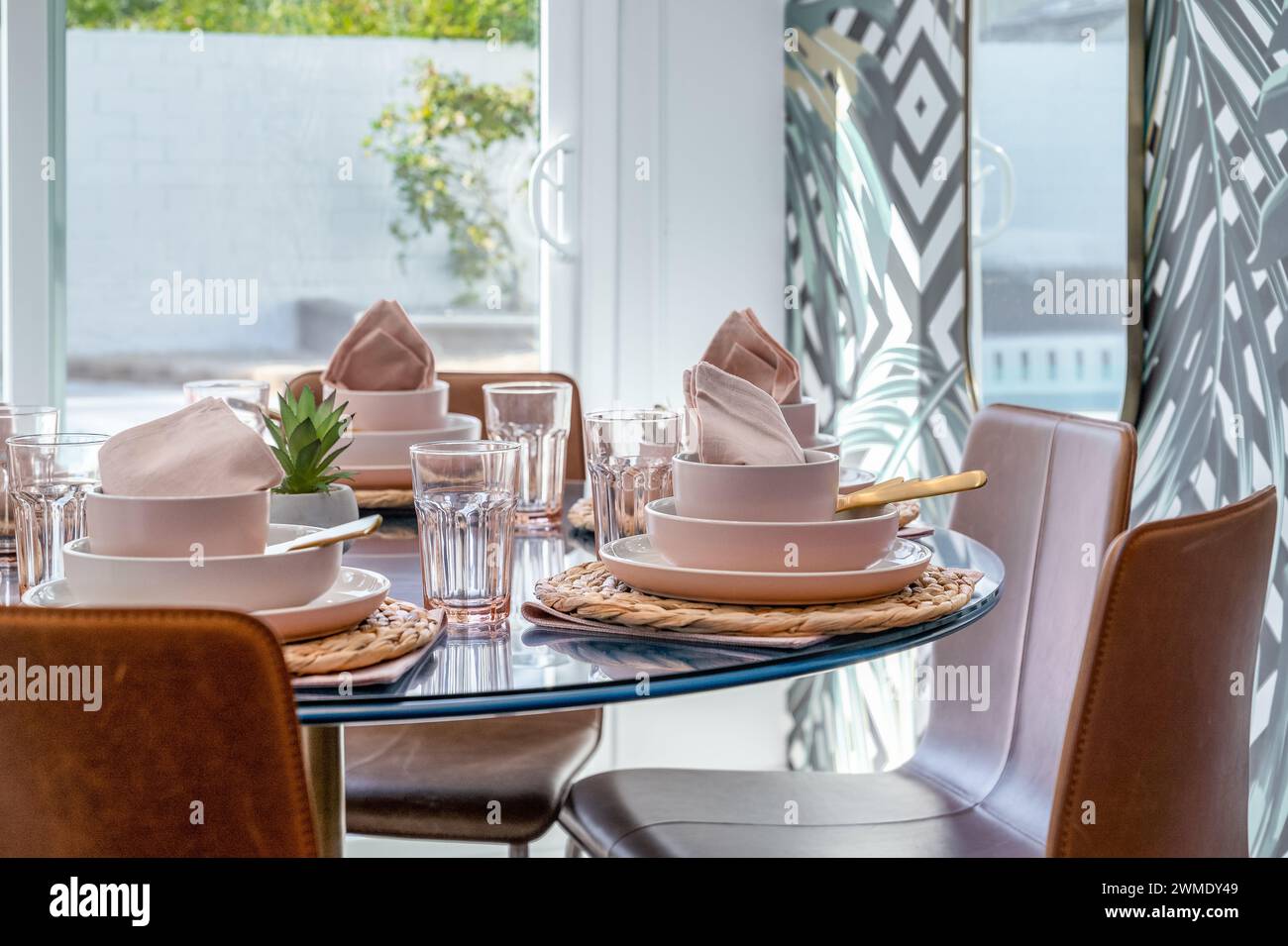 Tavolo da pranzo in cucina con tavolini rosa tenue Foto Stock