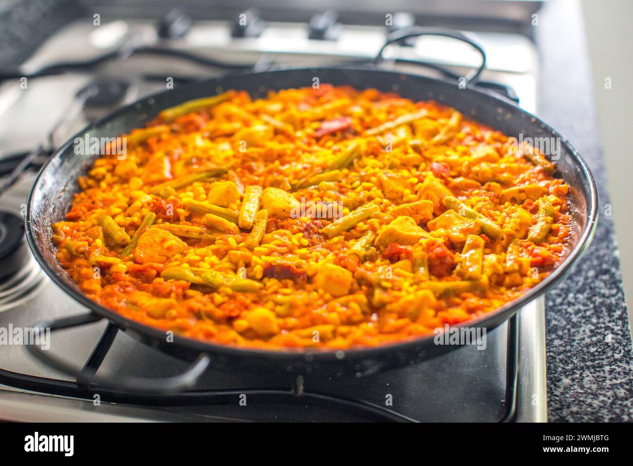 Una paella tradizionale spagnola colorata cucinata e servita. Foto Stock