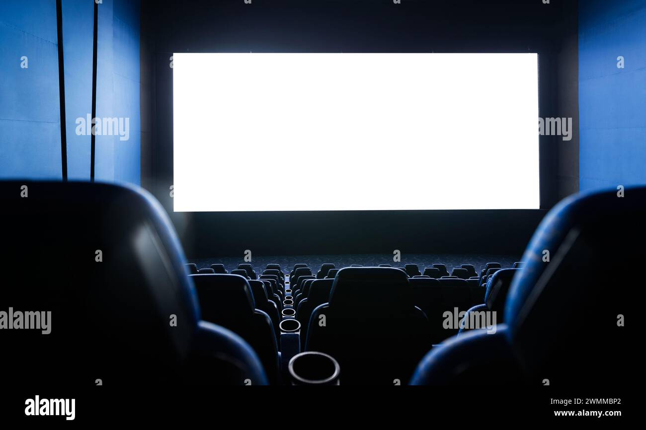 Interni scuri del cinema con schermo e sedie Foto Stock