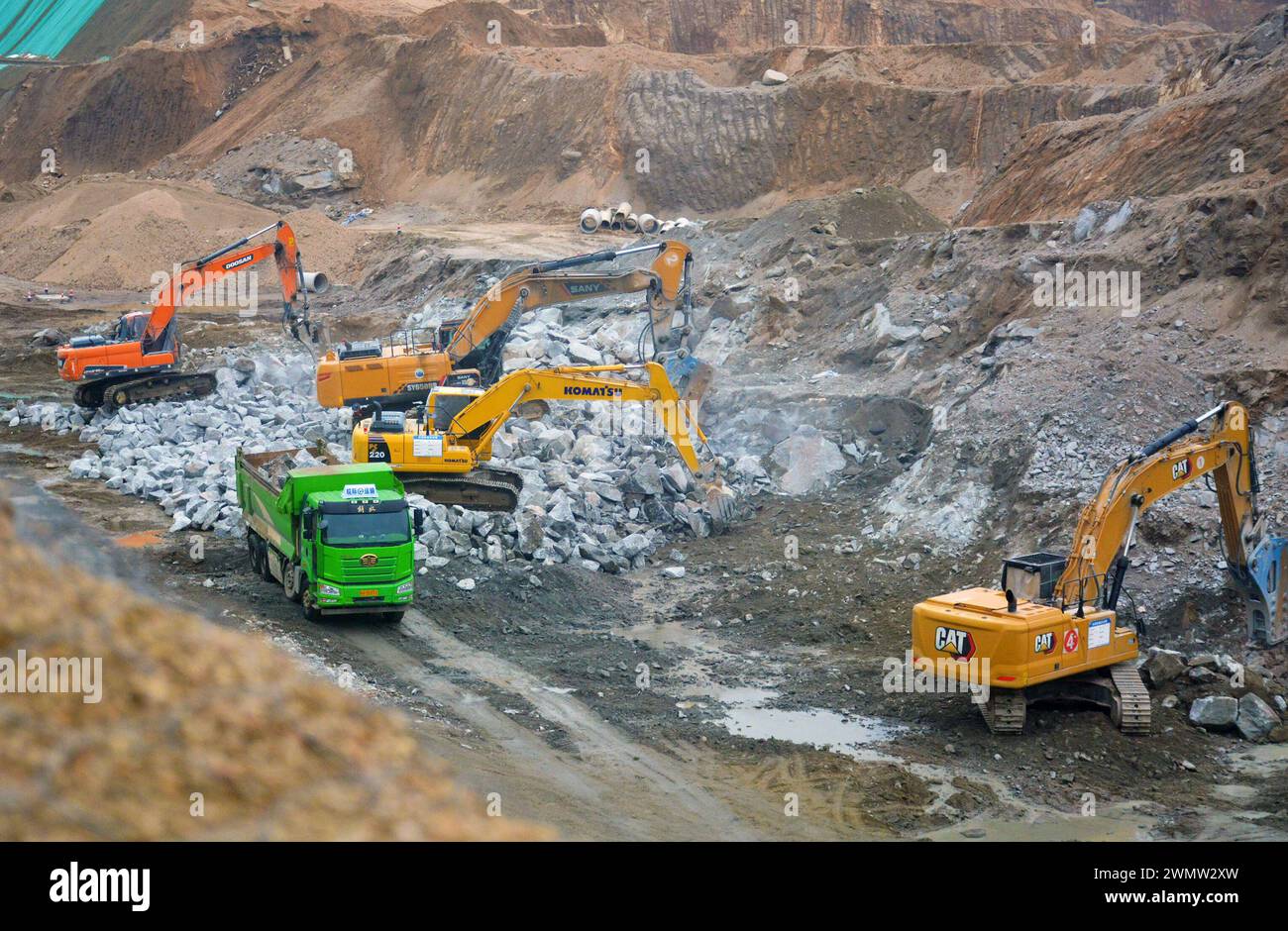 ANQING, CINA - 28 FEBBRAIO 2024 - i lavoratori guidano macchine per costruire infrastrutture di trasporto nella contea di Yuexi, città di Anqing, provincia di Anhui, Cina, Foto Stock