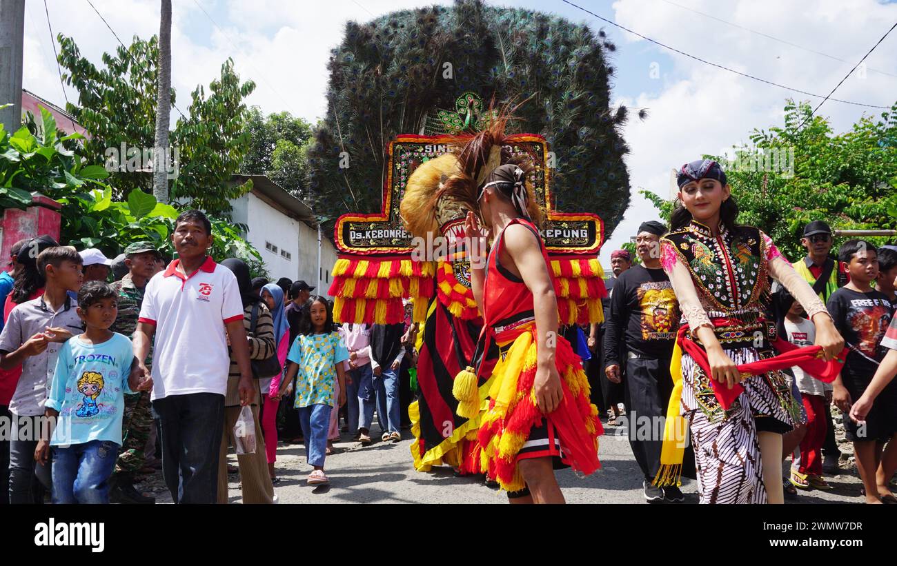 Il ballerino Reog Ponorogo sta eseguendo un balletto composto da ballerini mascherati che assomigliano alla grande tigre decorata con coda di pavone Foto Stock