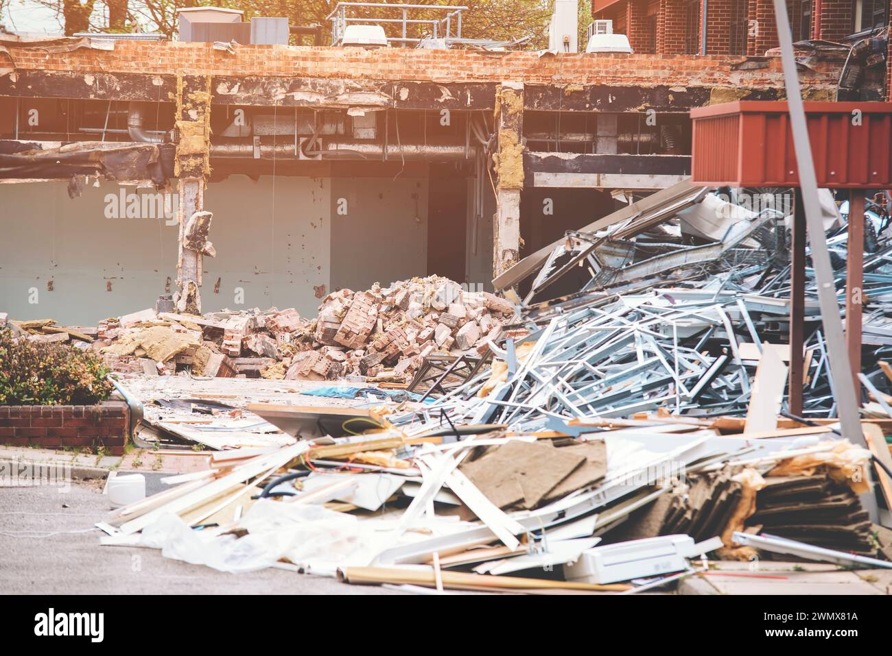 Demolizione di edifici. L'escavatore rompe la vecchia casa. Creazione di spazio per la costruzione di nuove case Foto Stock