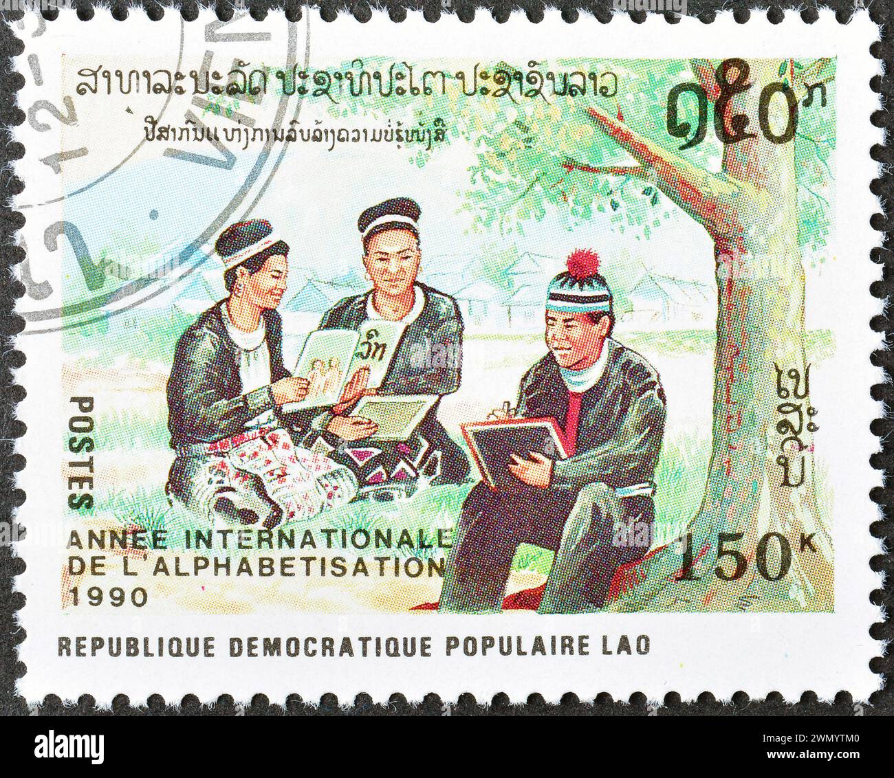 Francobollo cancellato stampato dal Laos, che mostra gli adulti che imparano a scrivere, anno internazionale dell'analfabetismo, circa 1990. Foto Stock