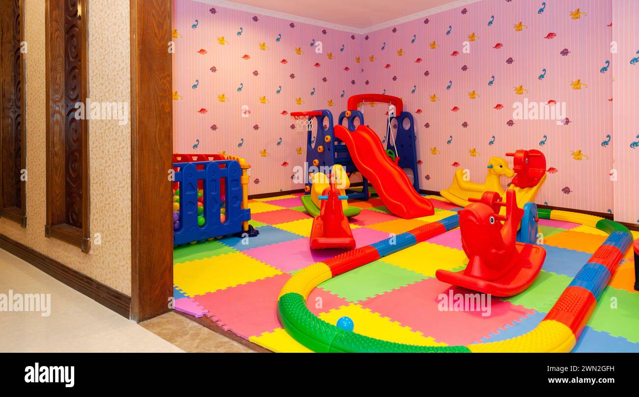 Interno della stanza dei bambini, con molti giocattoli sul pavimento Foto Stock