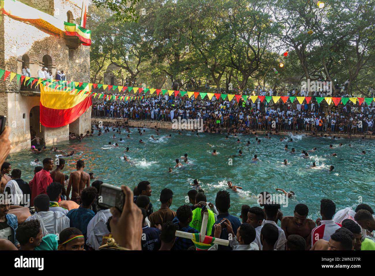GONDAR, ETIOPIA - 19 GENNAIO 2019: Giovani che nuotano in acqua Santa al festival Timkat a Fasilides Bath. Foto Stock