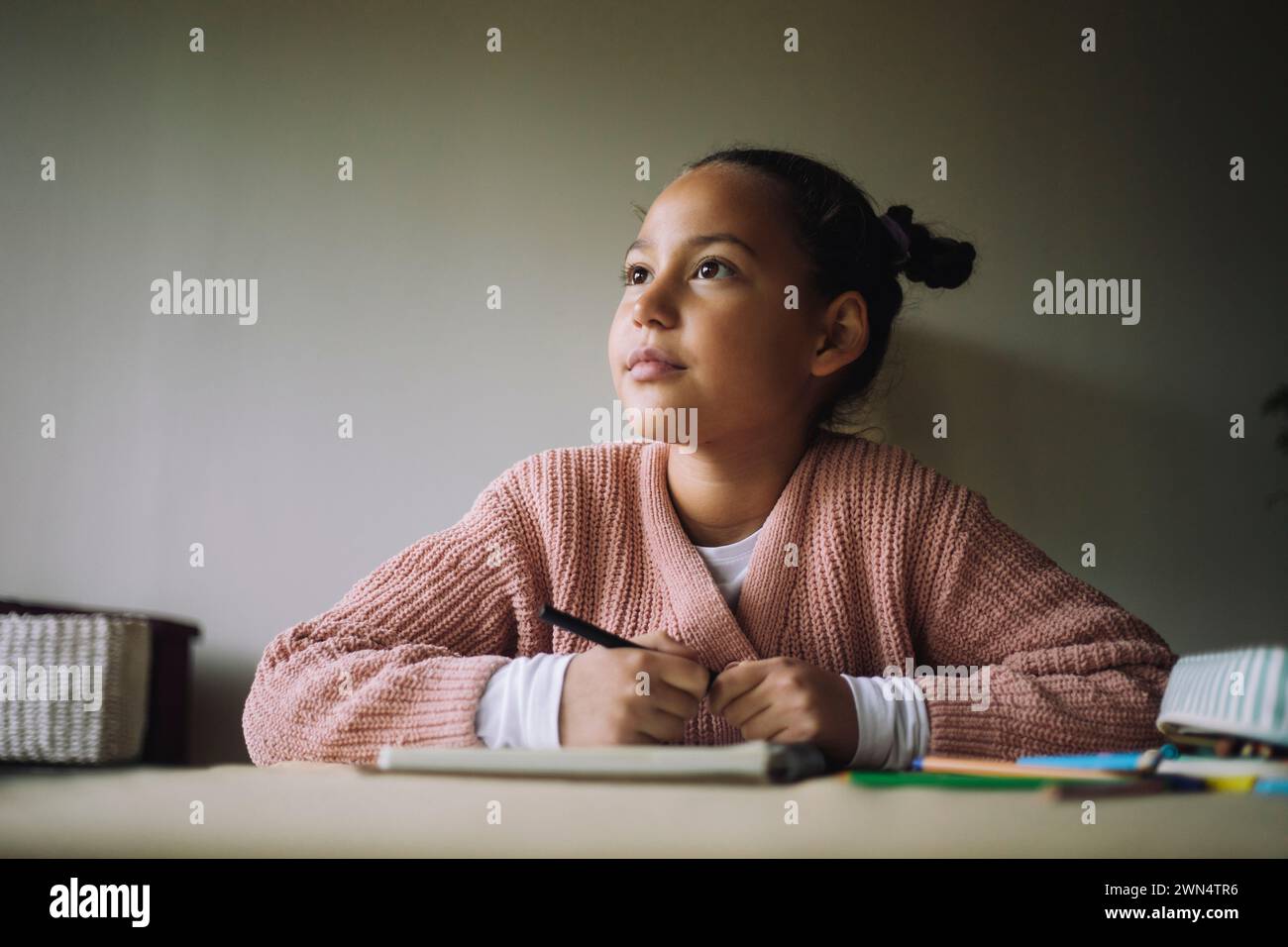 La giornata delle bambine che sognano mentre colorano a casa Foto Stock