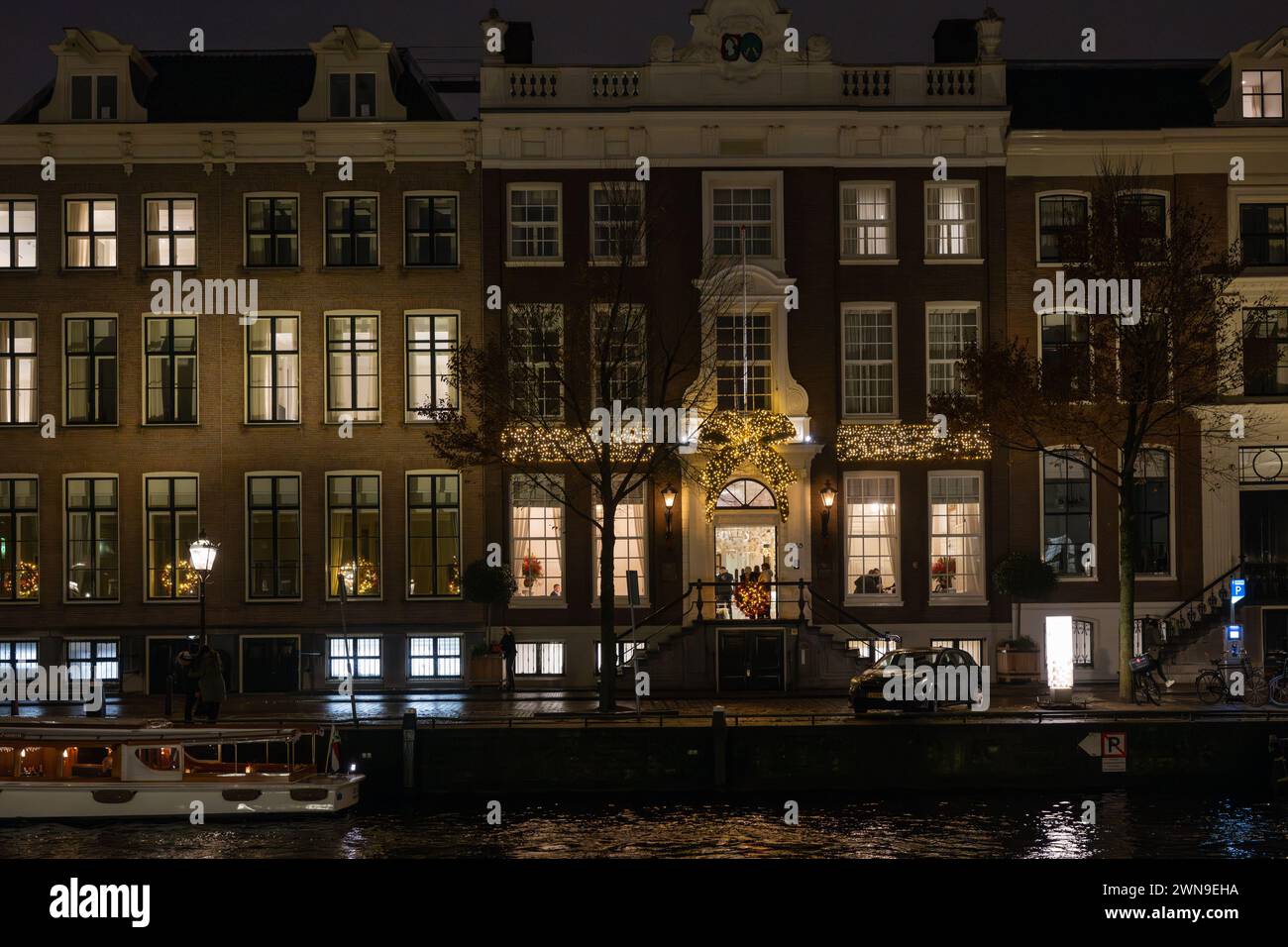 Le case si illuminano di notte sul canale Herengracht, Amsterdam, Paesi Bassi Foto Stock