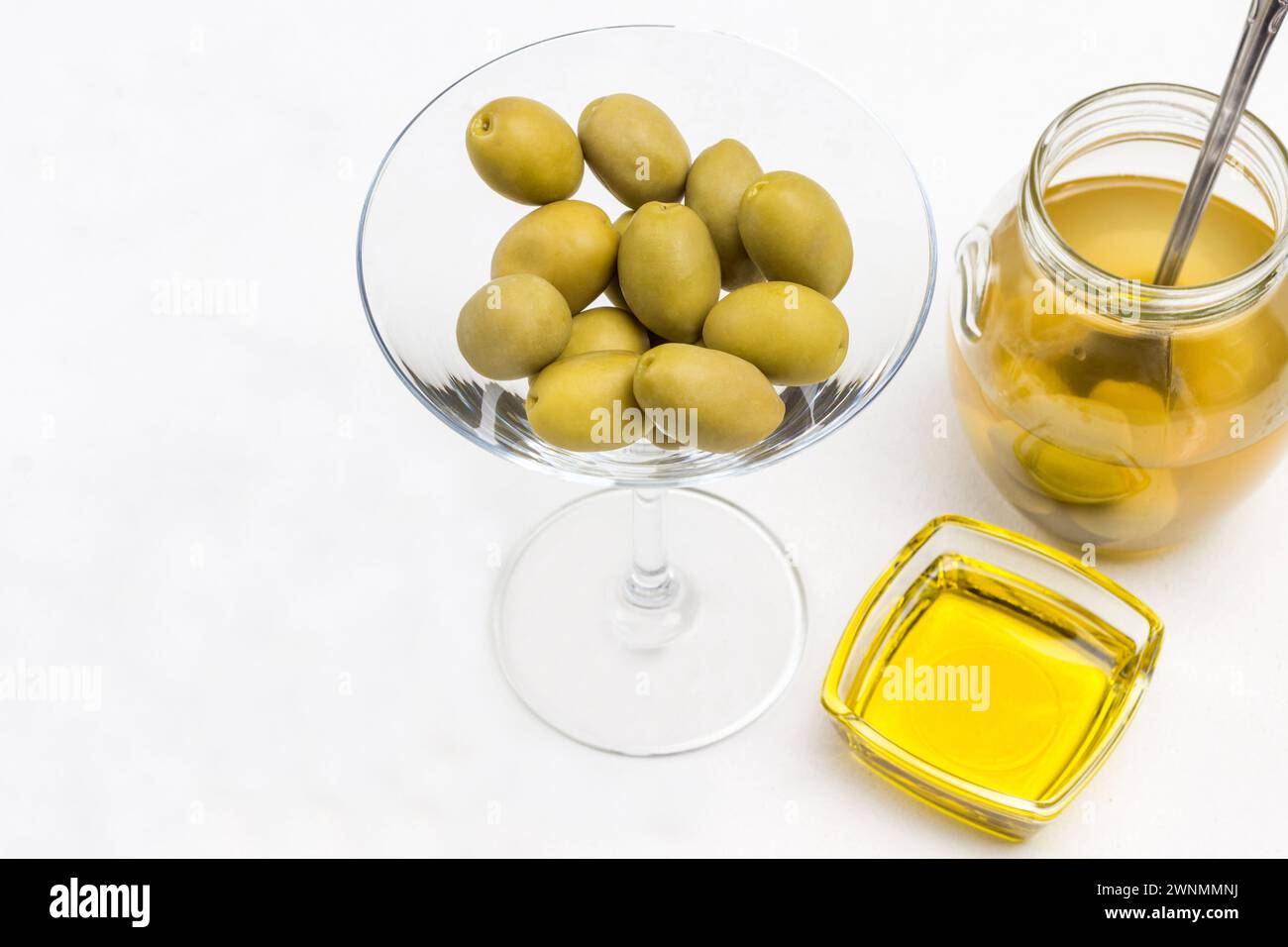 Oliva verde su fetta di pane. Barattolo di olive. Bottiglia d'olio. Sfondo bianco. Vista dall'alto Foto Stock